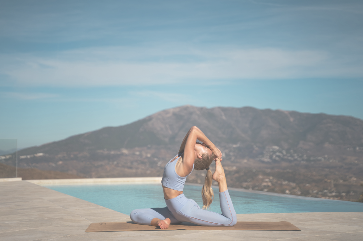 Mindful Path Person practicing yoga by a pool with mountains in the background